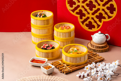 Assorted Chinese Dimsum in bamboo basket. Dimsum is a large range of small dishes that Cantonese people traditionally enjoy in restaurants for breakfast and lunch.