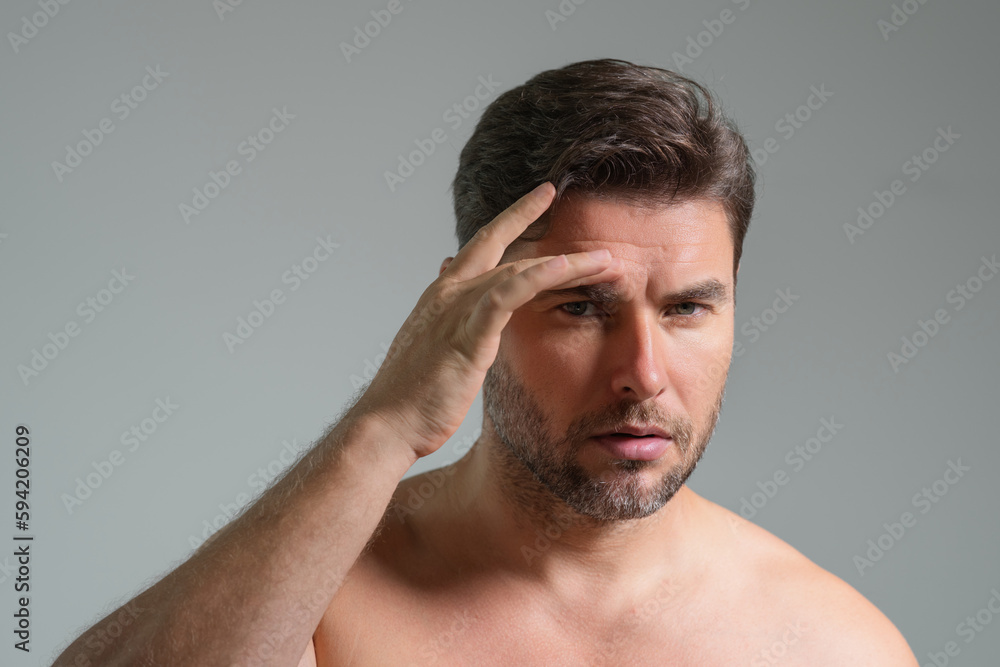 Close-up portrait of perfect brunet man touching chin and skin. Handsome man touching face in gray studio isolated background. Perfect skin. Man cosmetic, skin treatment. Hygiene skin care male face. Close-up portrait of perfect brunet man touching chin and skin. Handsome man touching face in gray studio isolated background. Perfect skin. Man cosmetic, skin treatment. Hygiene skin care male face.