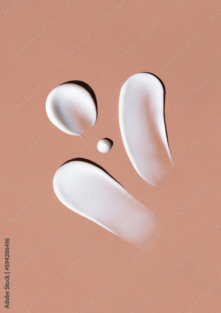 cosmetic smears cream texture on brown background cosmetic smears cream texture on brown background