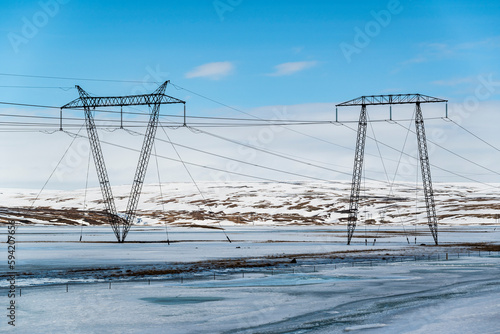 Two of the typical Icelandic transmission towers in a frosty winter landscape in upper Þjórsárdalur valley, Iceland photo