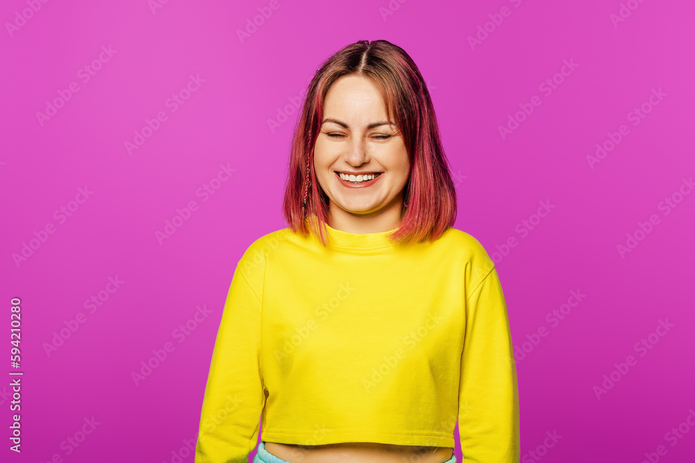 Portrait of happy and positive woman close eyes, smiling carefree, standing in yellow t-shirt on pink background Portrait of happy and positive woman close eyes, smiling carefree, standing in yellow t-shirt on pink background