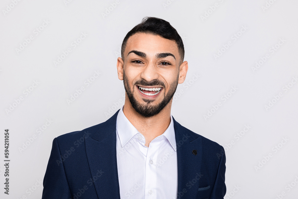 Portrait of happy delighted turkish man in studio isolated over grey background looking at camera smiling with white teeth buisneesman young successful guy. Portrait of happy delighted turkish man in studio isolated over grey background looking at camera smiling with white teeth buisneesman young successful guy.
