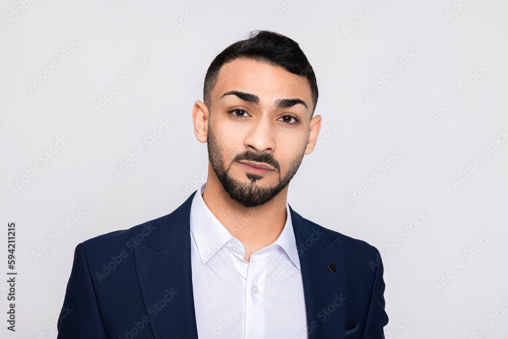 Portrait of serious concentrated in bad mood turkish man in studio isolated over grey background looking at camera smiling with white teeth buisneesman young successful guy. Portrait of serious concentrated in bad mood turkish man in studio isolated over grey background looking at camera smiling with white teeth buisneesman young successful guy.