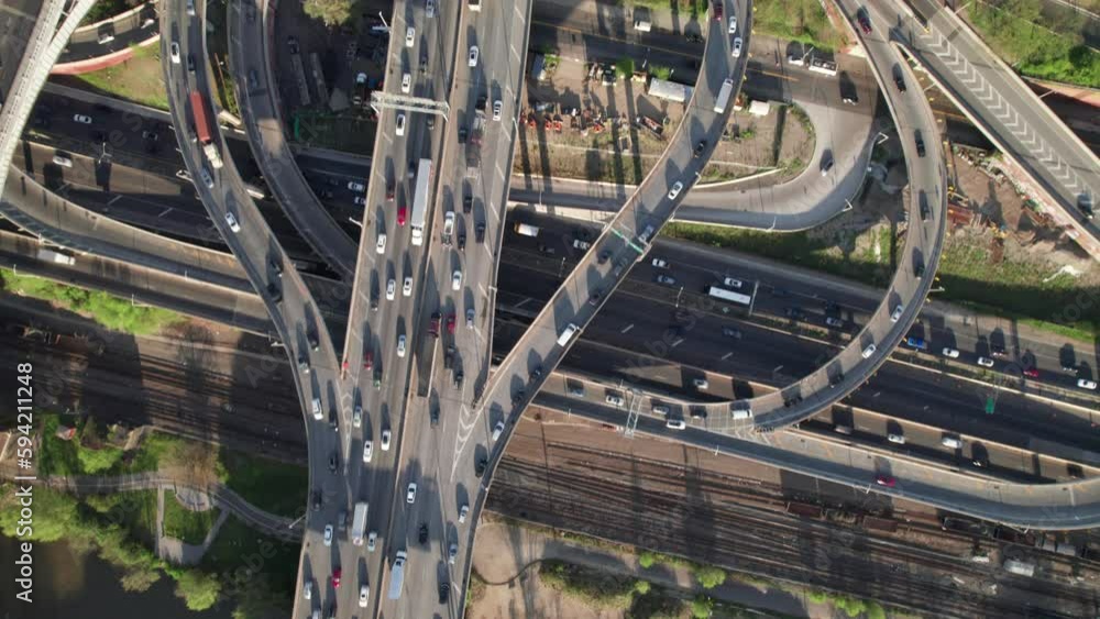 Vidéo Stock Overhead aerial of crazy traffic interchange with bridges ...