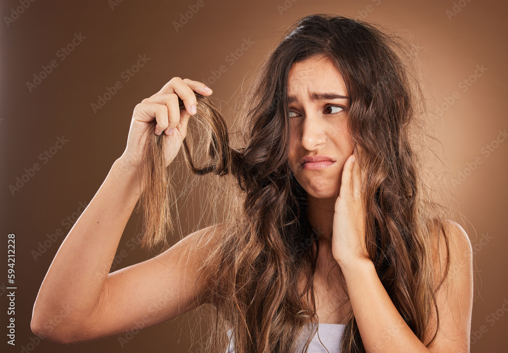 Obraz premium Hair loss, crisis and worried woman in studio for beauty, messy and damage against brown background. Haircare, fail and sad girl frustrated with weak, split ends or alopecia, dandruff and isolated