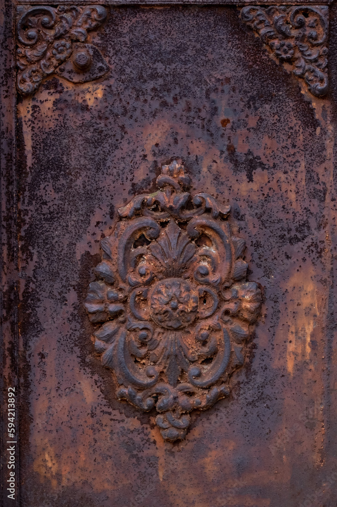 Close-up of an old metal gate with a pattern. Abstract old metal peeling surface texture for a background. Close-up of an old metal gate with a pattern. Abstract old metal peeling surface texture for a background.