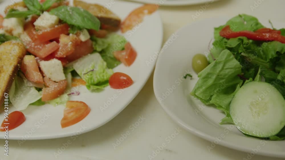 Serving italian salad and parmesan cheese sprinkle dolly left Serving italian salad and parmesan cheese sprinkle dolly left