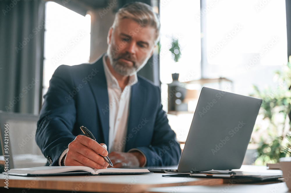 Senior businessman is working in the office Senior businessman is working in the office