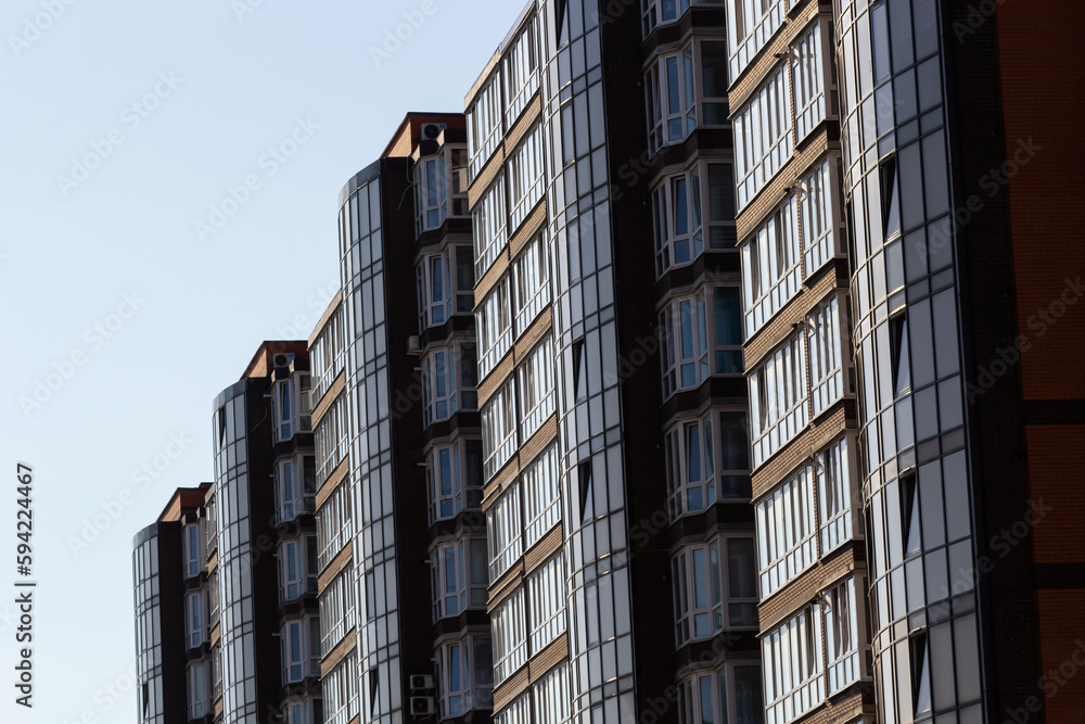 Architectural details of modern high apartment building facade with many windows and balconies Architectural details of modern high apartment building facade with many windows and balconies