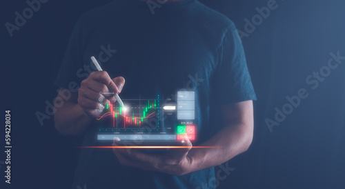 invesment concept. man using tablet analysing virtual trading graph, cryptocurrency stock market exchange