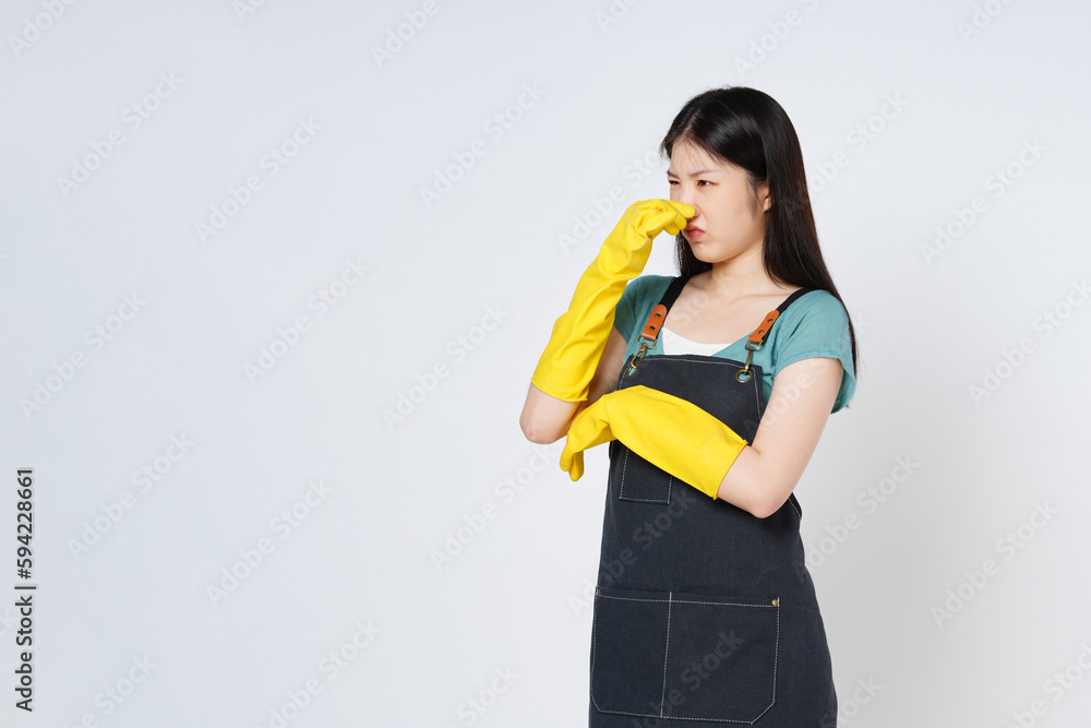 Portrait of young woman wearing yellow rubber gloves covered her nose with her hand an unpleasant smell isolated on white background. Portrait of young woman wearing yellow rubber gloves covered her nose with her hand an unpleasant smell isolated on white background.