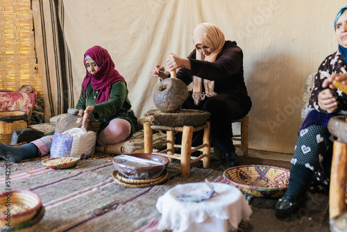 Moroccan women working in cooperative for extraction of argan nuts oil