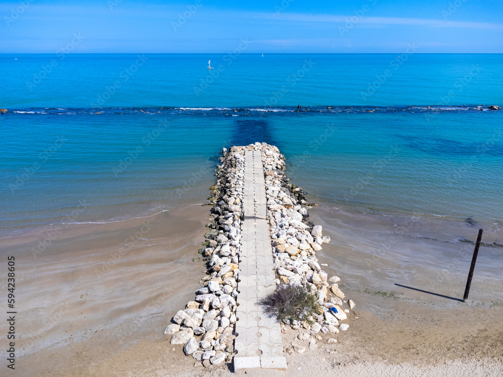 Aerial view landscape Italy Pescara. View of the sea, empty beach, path to the water, pier, rocks.