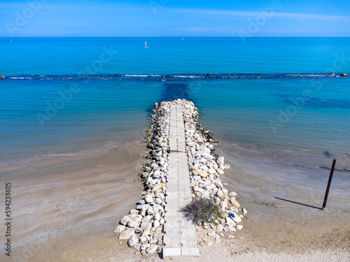 Obraz na płótnie Aerial view landscape Italy Pescara. View of the sea, empty beach, path to the water, pier, rocks. w salonie