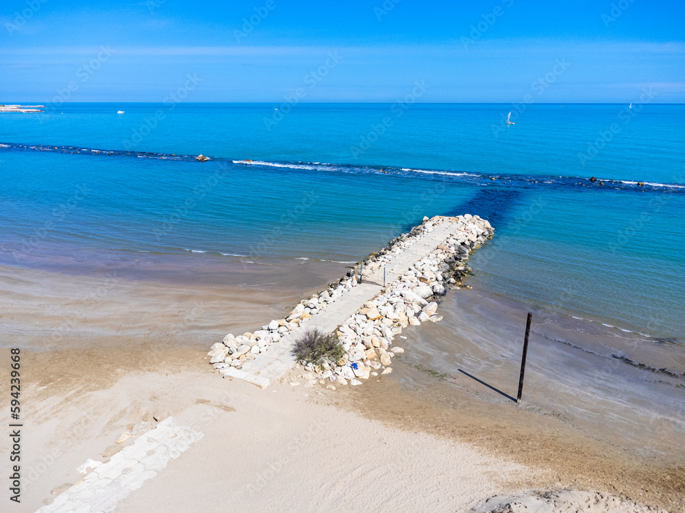 Aerial view landscape Italy Pescara. View of the sea, empty beach, path to the water, pier, rocks.