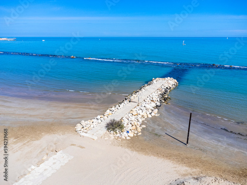 Obraz na płótnie Aerial view landscape Italy Pescara. View of the sea, empty beach, path to the water, pier, rocks. w salonie