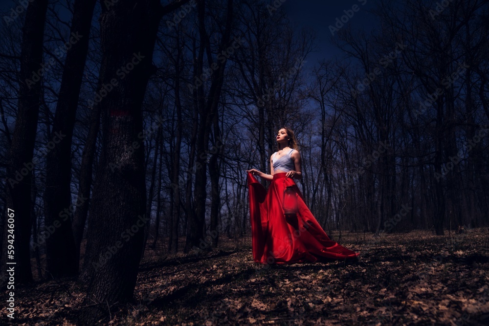 Caucasian female in a beautiful dress in the forest