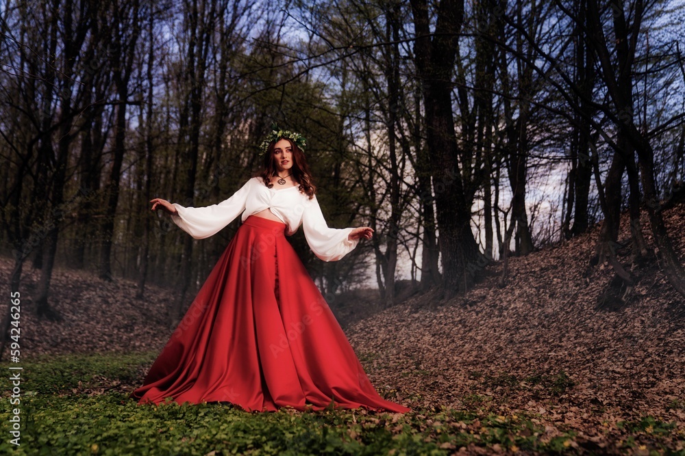 Caucasian female in a beautiful dress in the forest Caucasian female in a beautiful dress in the forest