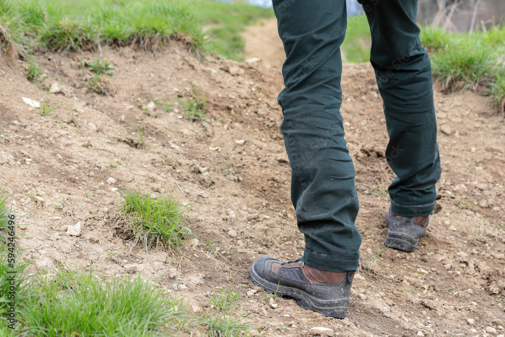 The traveler walks the road through a hill. The traveler walks the road through a hill.