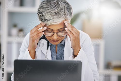 Woman doctor, laptop and headache or stress from burnout in hospital office while working. Medical professional female with anxiety, mental health problem and depression from healthcare results