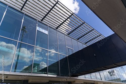 wiss Airport Zürich Kloten with reflections in glass facade with lettering at terminal named Dock Midfield on a sunny spring morning. Photo taken April 14th, 2023, Kloten, Canton Zurich, Switzerland.