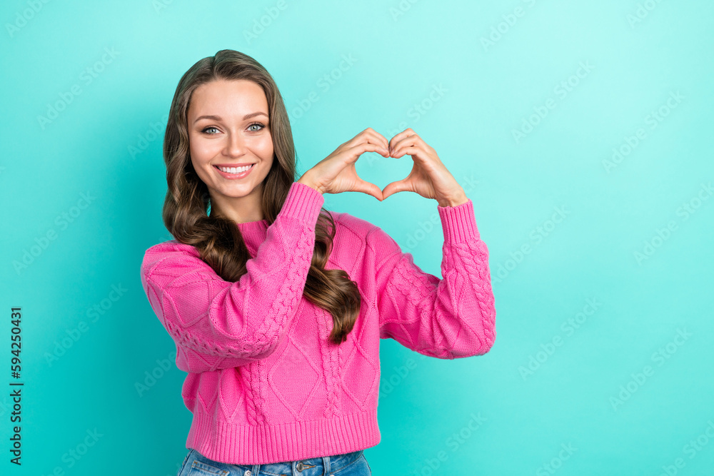 Fototapeta premium Portrait of positive adorable pretty lady wear trendy clothes arms demonstrate heart symbol empty space isolated on cyan color background