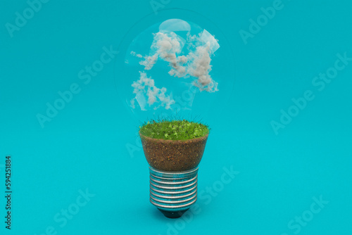 Fototapeta Naklejka Na Ścianę i Meble -  single lightbulb with green soil and clouds; renewable clean energy concept; 3D Illustration