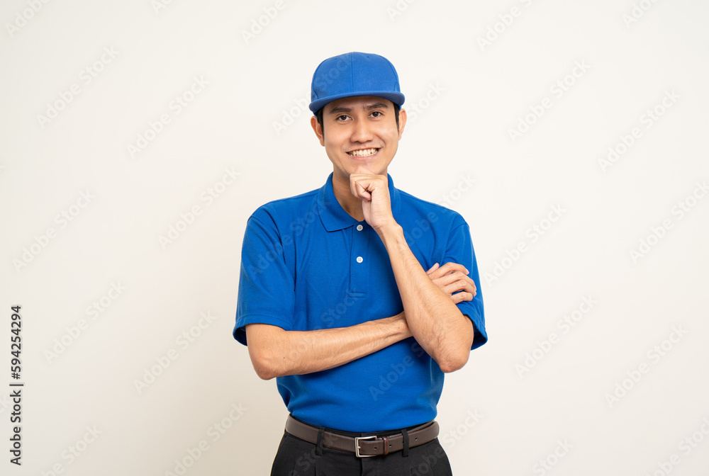 Happy delivery asian man in blue uniform standing thinking on isolated white background. Smiling male delivery service worker. Courier and shipping service. Happy delivery asian man in blue uniform standing thinking on isolated white background. Smiling male delivery service worker. Courier and shipping service.