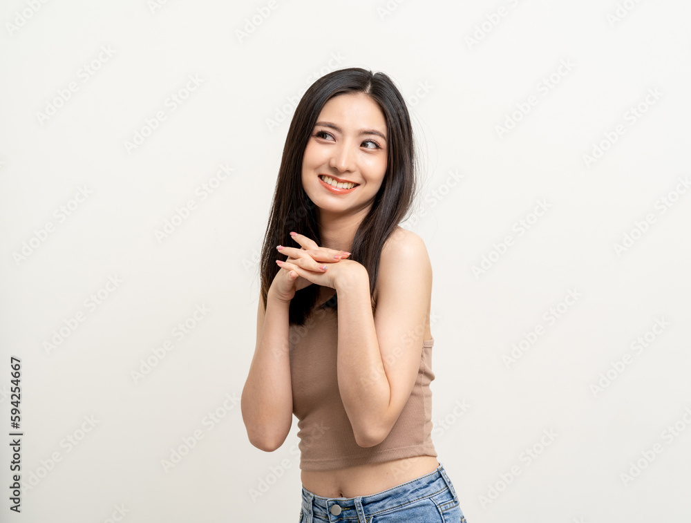 Beautiful smiling happy young asian woman in brown shirt. Charming female lady standing pose thinking on isolated white blank background. Asian cute people looking copy space for text advertise Beautiful smiling happy young asian woman in brown shirt. Charming female lady standing pose thinking on isolated white blank background. Asian cute people looking copy space for text advertise