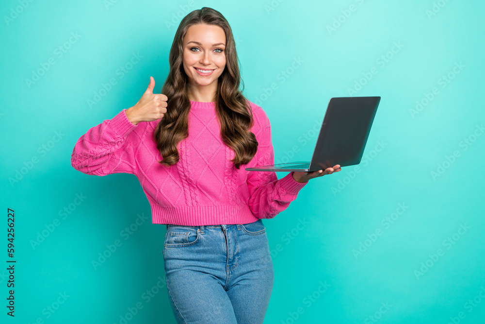 Portrait of glamour pretty lovely lady wear trendy pink clothes thumb up nice quality modern device shop isolated on cyan color background Portrait of glamour pretty lovely lady wear trendy pink clothes thumb up nice quality modern device shop isolated on cyan color background