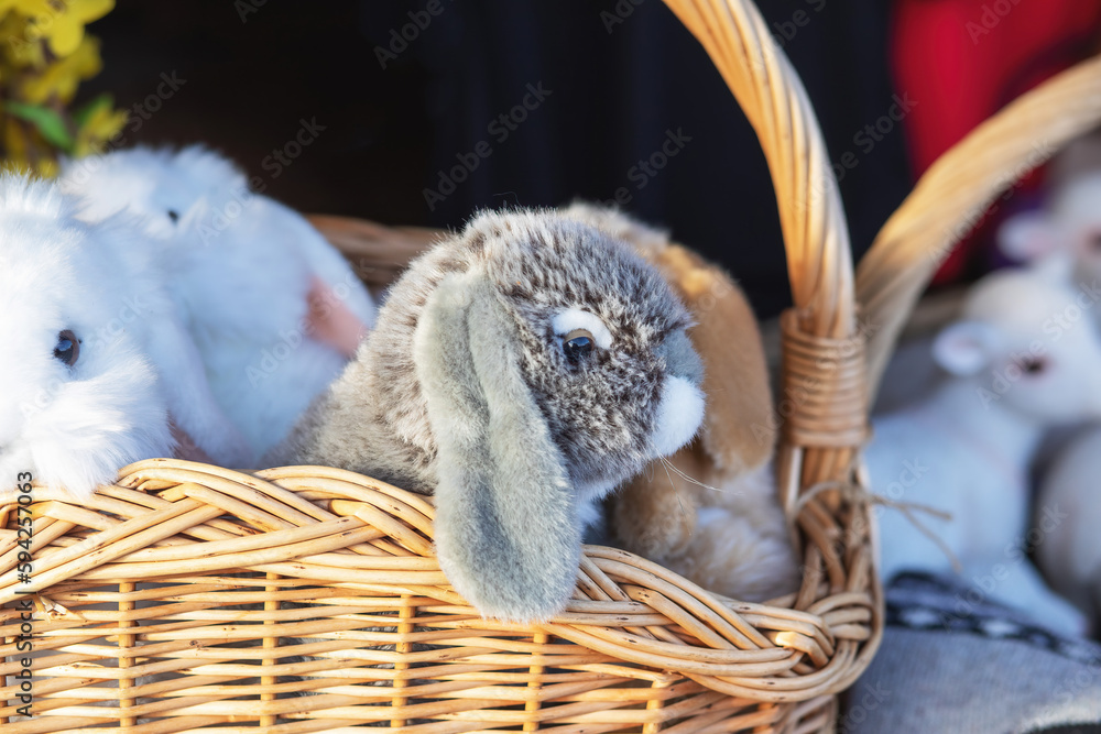 Obraz premium Plush bunnies in wicker basket.Easter decoration.