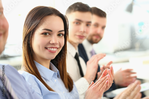 Business smiling people hands applauding at conference. Successful young business lady at meeting greets boss © H_Ko
