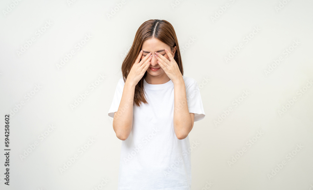 Young asian beautiful woman hand rubbing eyes she's feeling depressed stress headache be tired from working standing on isolated white background she has health problems. - obrazy, fototapety, plakaty 