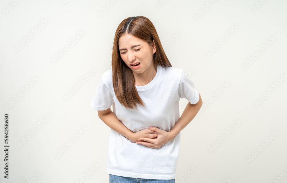 A woman had a stomach ache and gastritis. She put her hand on her stomach and squeezed it to relax and soothe. She is 25 years old and has menstrual cramps. Shot on isolated white background. A woman had a stomach ache and gastritis. She put her hand on her stomach and squeezed it to relax and soothe. She is 25 years old and has menstrual cramps. Shot on isolated white background.