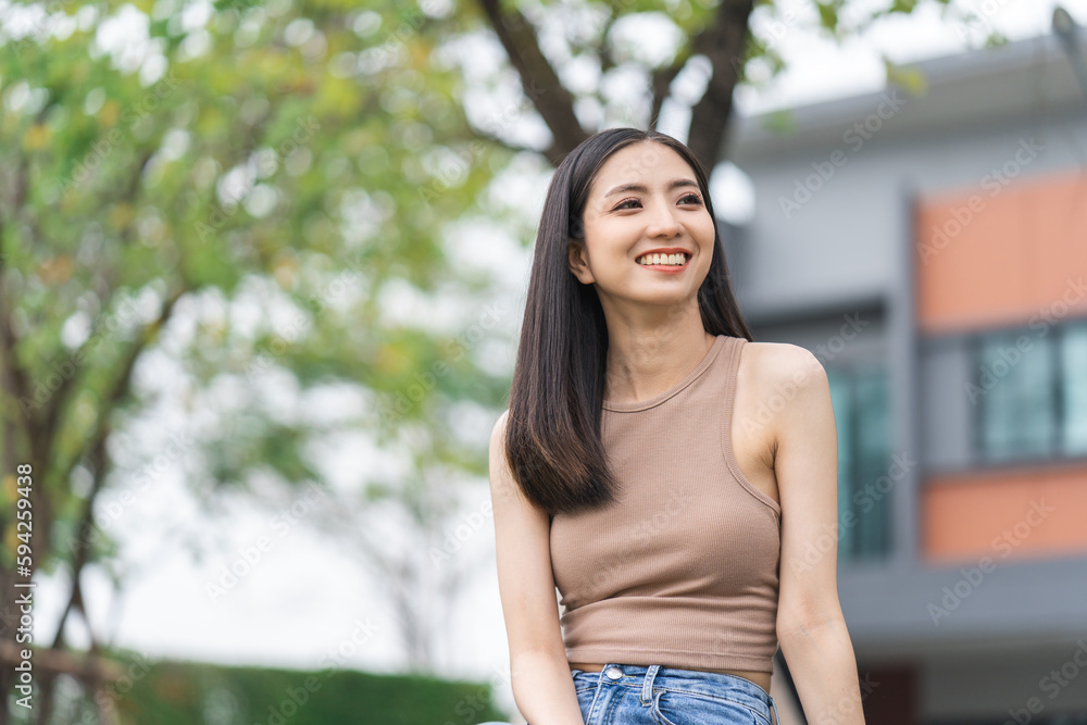 Fototapeta premium Happy feeling of Beautiful Young Woman smiling outdoor in sunlight. Pretty attractive face of female and beautiful smile. She is positive thinking and successful.