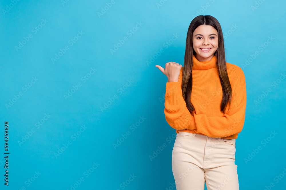 Photo of pleasant gorgeous girl long hairstyle wear knit turtleneck indicating at sale empty space isolated on blue color background Photo of pleasant gorgeous girl long hairstyle wear knit turtleneck indicating at sale empty space isolated on blue color background