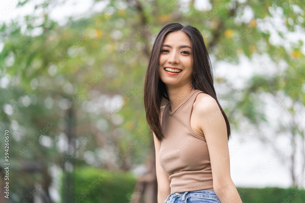 Happy feeling of Beautiful Young Woman smiling outdoor in sunlight. Pretty attractive face of female and beautiful smile. She is positive thinking and successful. Happy feeling of Beautiful Young Woman smiling outdoor in sunlight. Pretty attractive face of female and beautiful smile. She is positive thinking and successful.
