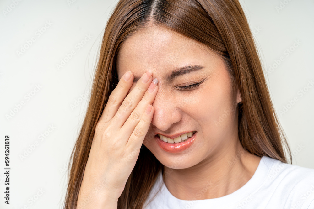 Young asian beautiful woman hand rubbing eyes she's feeling depressed stress headache be tired from working standing on isolated white background she has health problems. Young asian beautiful woman hand rubbing eyes she's feeling depressed stress headache be tired from working standing on isolated white background she has health problems.