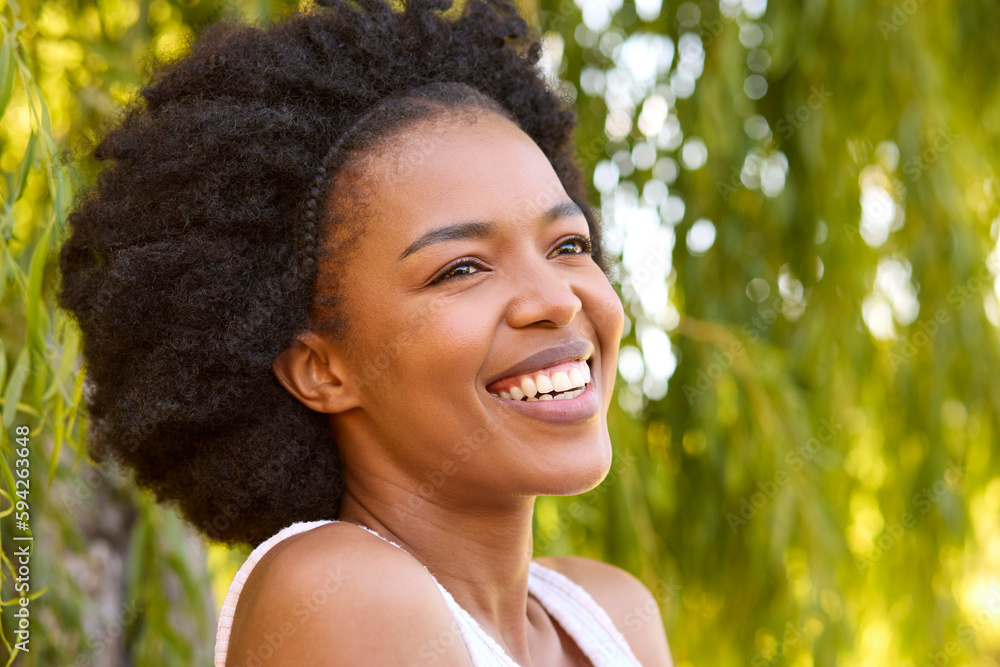 Portrait Of Smiling Beautiful Woman Standing By Tree In Garden At Home Portrait Of Smiling Beautiful Woman Standing By Tree In Garden At Home