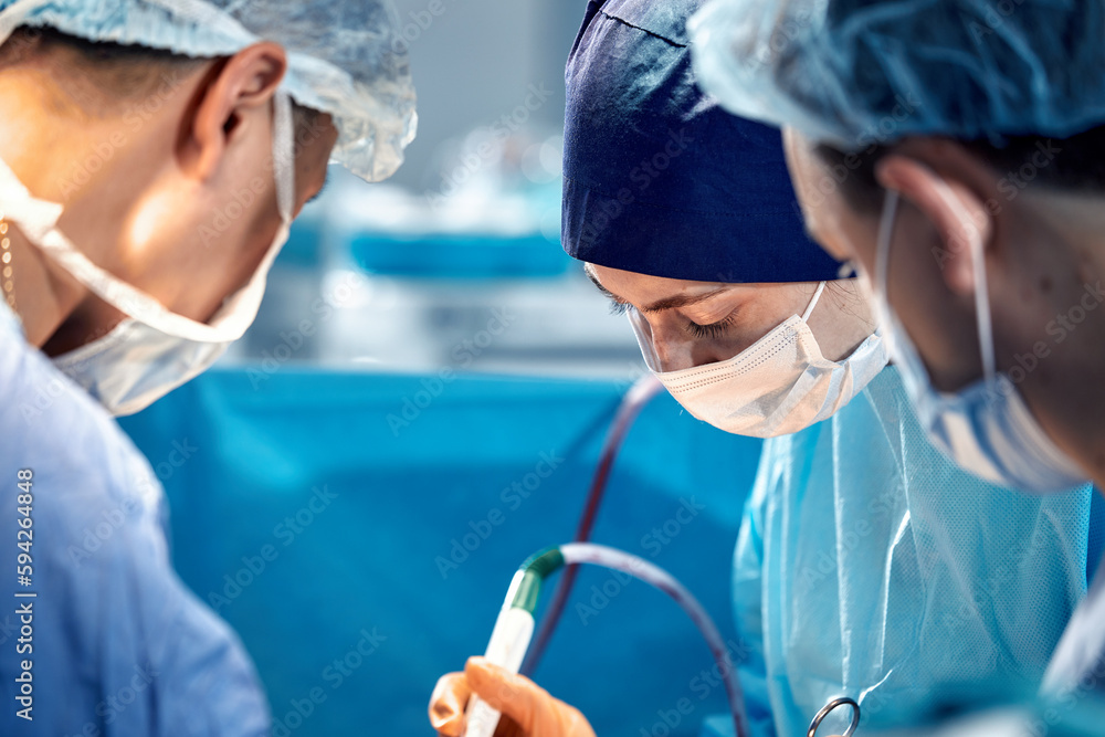 International team of surgeons in the operating room during the operation. Modern medicine, international medical workers during a complex operation, modern medicine. International team of surgeons in the operating room during the operation. Modern medicine, international medical workers during a complex operation, modern medicine.