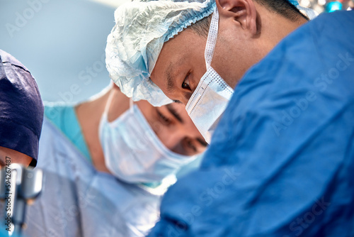 faces of surgeons in the operating room during the operation. Modern medicine  medical workers during a complex operation  modern medicine