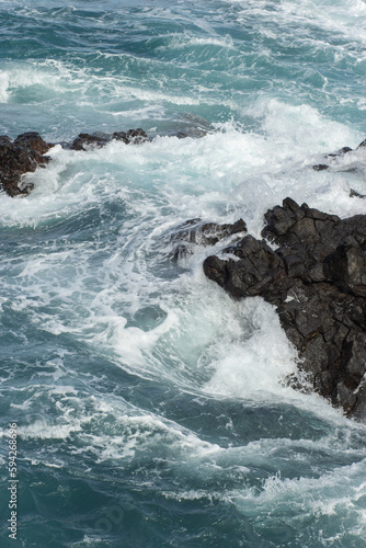 beautiful view on the ocean with stones and waves