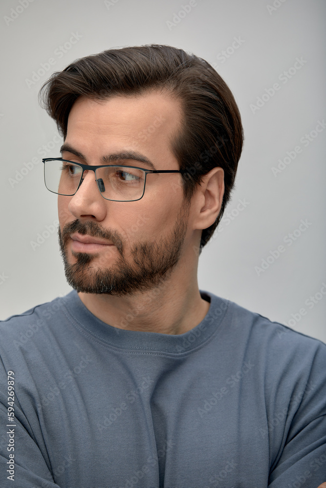 Portrait of a happy millennial business owner in a modern office. Businessman with glasses looking at the camera. Leadership concept. Headshot Portrait of a happy millennial business owner in a modern office. Businessman with glasses looking at the camera. Leadership concept. Headshot