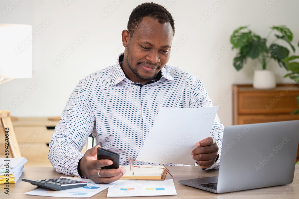African black businessmen sit on mobile phones communicating with clients and making financial reports and studying annual profit analysis. An accountant checks the financial status of the company. African black businessmen sit on mobile phones communicating with clients and making financial reports and studying annual profit analysis. An accountant checks the financial status of the company.
