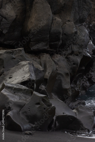 beautiful view of black textured stone beach