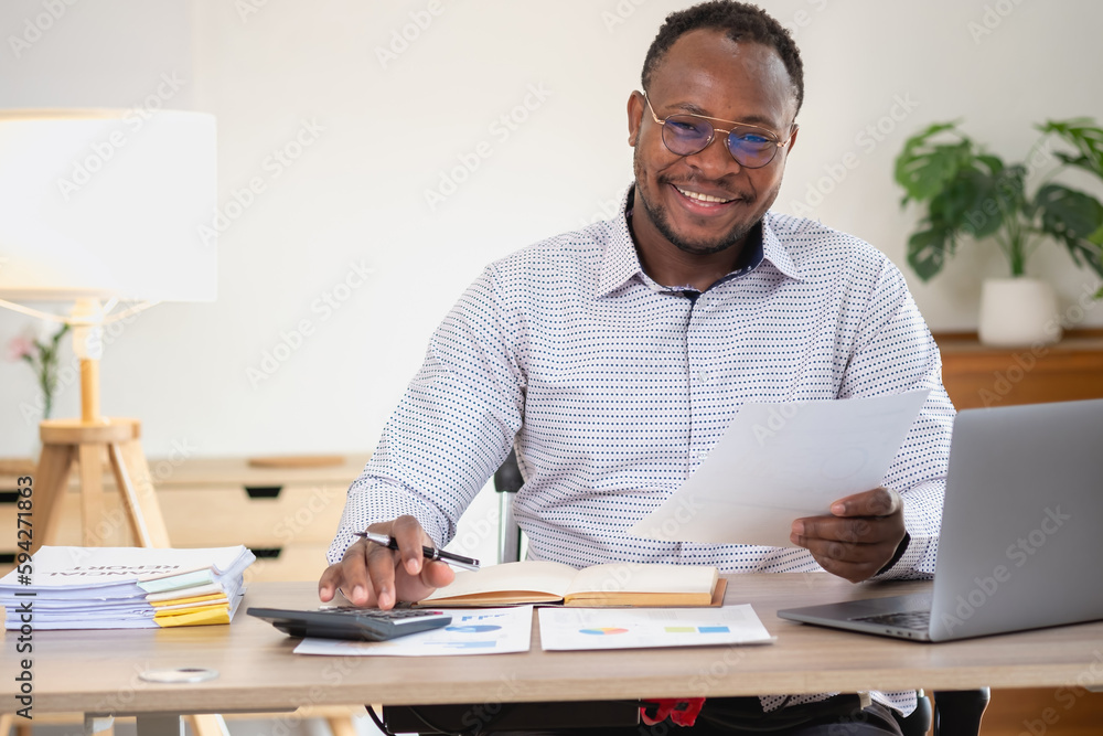 African American businessman smiling relaxed and crossed arms after analysis and research at home office African American businessman smiling relaxed and crossed arms after analysis and research at home office