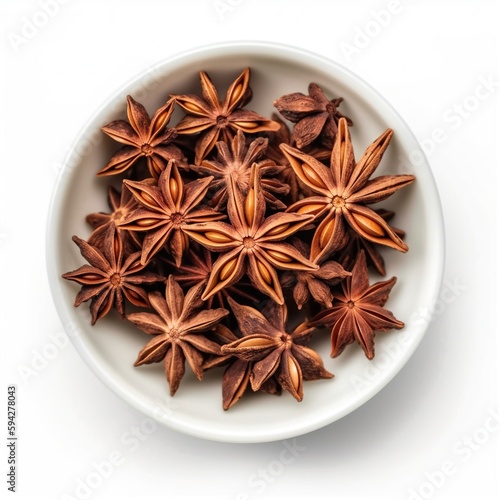 Anise star in white bowl isolated on white. Top view. Ingredient, seasoning, recipe.