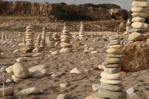 Sticker Stone towers stacked with stones on a Cypriot beach