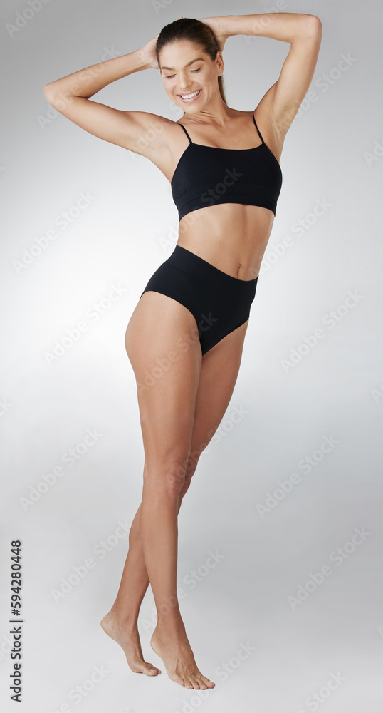 Looking fit and feeling fabulous. Studio shot of an attractive young woman posing in her underwear against a grey background. Looking fit and feeling fabulous. Studio shot of an attractive young woman posing in her underwear against a grey background.