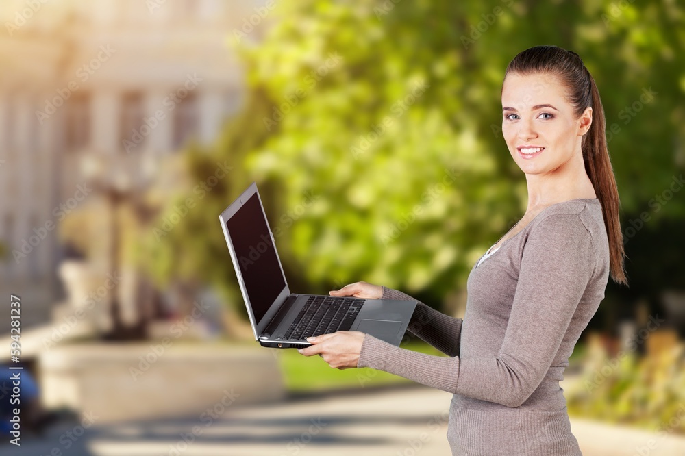 Young businesswoman working on modern laptop Young businesswoman working on modern laptop